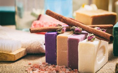 Variety of soap bars on wooden background