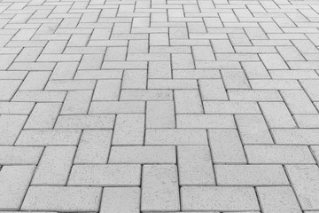 Paver brick floor also call brick paving, paving stone or block paving. Manufactured from concrete or stone for road, path, driveway and patio. Empty floor in perspective view for texture background.