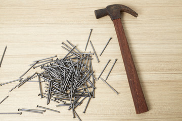 Hammer and nails on wood background