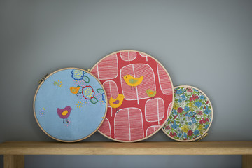 Birds and Flowers Embroidery in Embroidery Hoops on Wooden Shelf