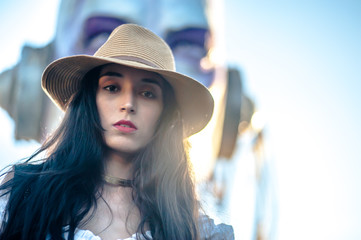 model young woman brunette with long and dark hair, posing outdoors