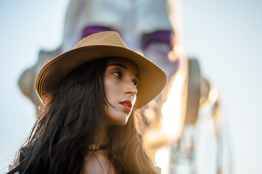 model young woman brunette with long and dark hair, posing outdoors