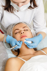 Obraz na płótnie Canvas Dermabrasion girl chin. Apparatus cosmetology. Spa. Facial Rejuvenation. Mechanical peeling skin.