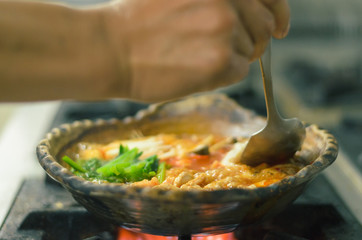 Japanese food vegetable  steaming in clay pot on fire stove