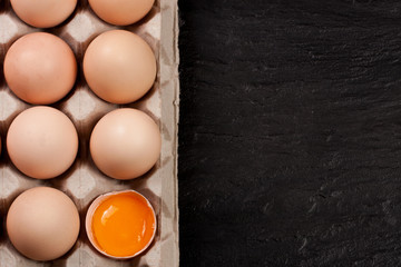 eggs in a tray on a dark background with copy space for your text. Top view