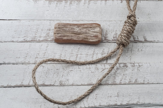 Loop with soap on wooden background