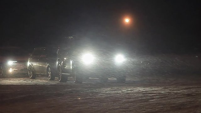 Blizzard, car traffic at night in city