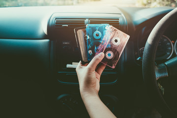 Woman hand holding tape cassette in car for driving listen music - vintage color tone effect.