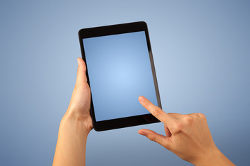 Female hand holding tablet