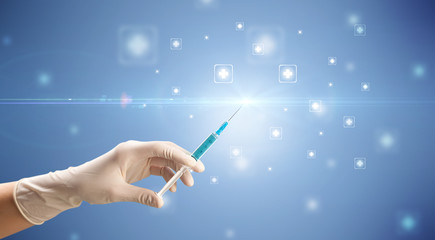 Female doctor holding syringe