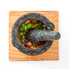 Cook thai style spicy chili red sauce in mortar with pestle