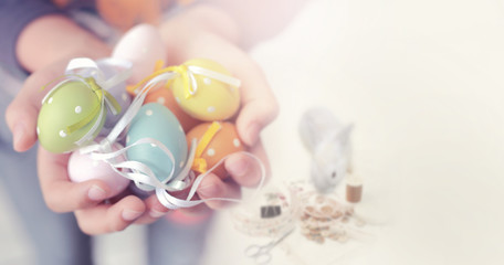 Colorful Easter eggs in child hands with copy space for texts,soft focus and vintage color toned.