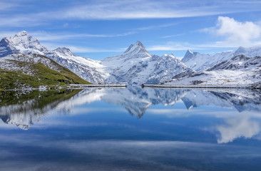 The snow mountain with reflection in lake and clear blue sky in Switzerland