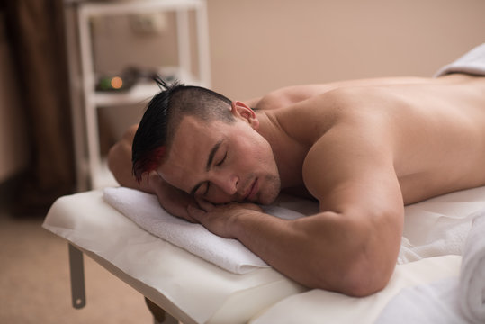 handsome man resting in a spa massage center
