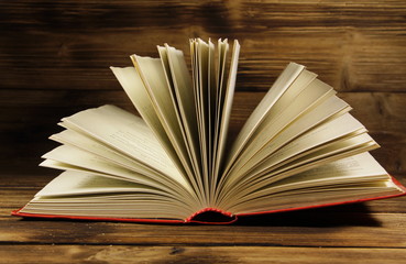 Open book on wooden background
