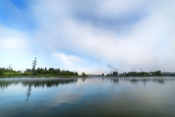 Kursk Nuclear Power Plant reflected in a calm water surface.