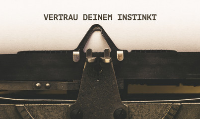 Vertrau deinem Instinkt, German text for Trust Your Instinct on vintage type writer from 1920s