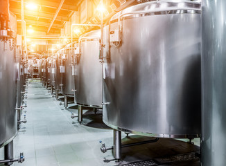 Rows of steel tanks for beer fermentation and maturation.