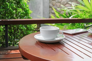 coffee cup on the wood floor background