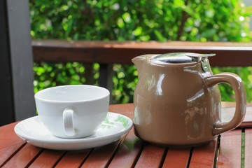 coffee cup on the wood floor background