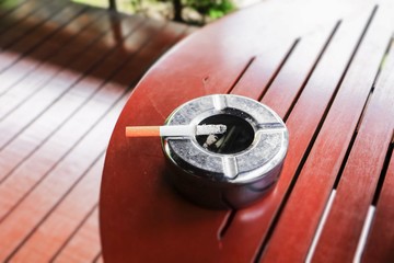 Cigarette in ashtray Placed on table wood  background