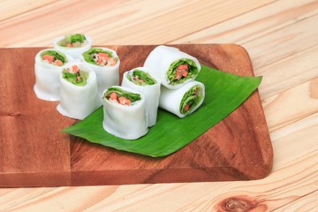 spring roll with vegetable on banana leaf wood floor background , Select focus  shallow depth of field.