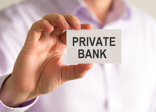 Businessman holding a card with PRIVATE BANK message