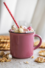 a delicious Cup of cocoa with marshmallows and straws