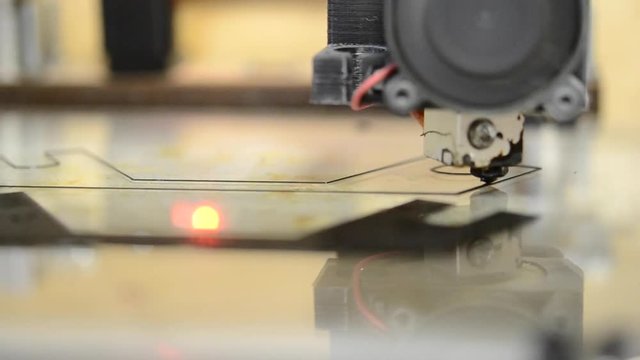 Automatic three dimensional 3d printer performs plastic black colors modeling in laboratory On a mirror surface with reflection. Timelapse.