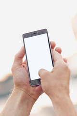 Taking photo with smartphone. Hands holding and touch on blank mobile with clipping path for screen.