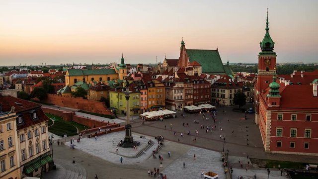 Warsaw, Poland time-lapse. Nightlife in Warsaw, Poland, people at the palace square. Illuminated historical buildings at night. Time-lapse at sunset with colorful sky