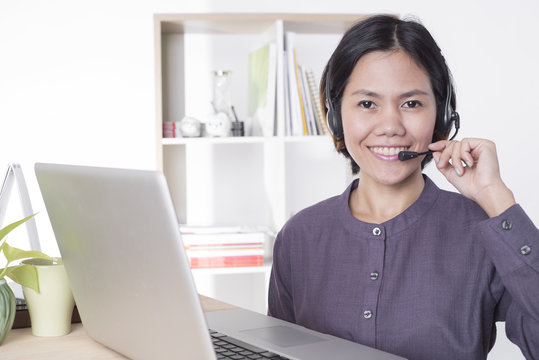 Asia women happy smiling customer support operator with headset in office.
