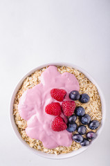 Oatmeat in bowl with yogurt and berries