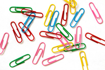 Scattered colored staples on a piece of paper