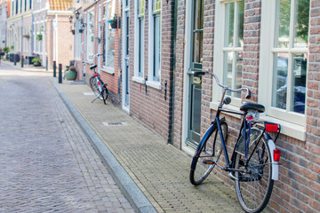 Fototapeta na wymiar AMSTERDAM, NETHERLANDS - September 22, 2014: beautiful view on street with bicycles