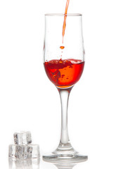 Red wine is poured into a glass On a white background