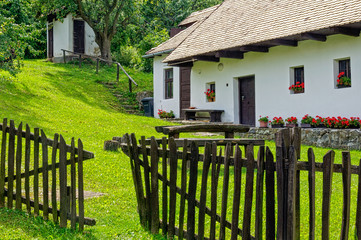 The fence and backyard of a farmhouse in  Holloko, Hungary