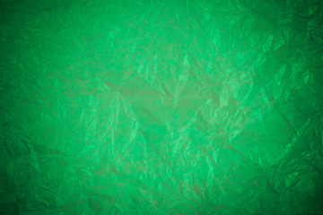 Crumpled green paper recycling background.