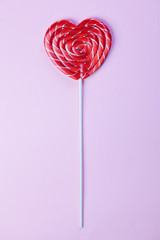 One candy heart shape on pink background