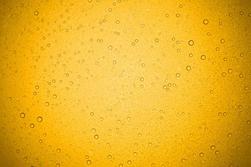 Water drops on yellow glass, Rain droplets on glass background.