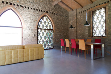 living room in a rustic loft with large windows