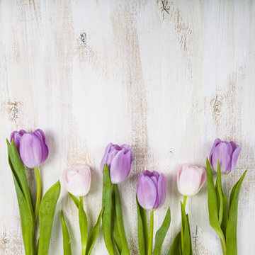 Bouquet of tulips on a wooden background.