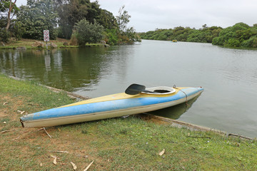 kayak and paddle with water safety sign in background