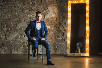 young businessman in blue suit emotional posing