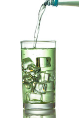 Water is poured into a glass with ice cubes