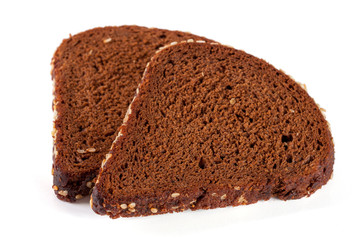 Two slices of black bread with sesame seeds isolated on white background