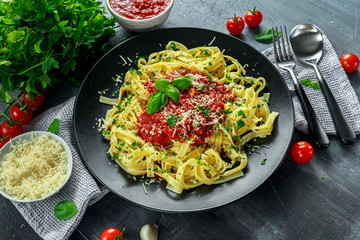 Homemade Hot Pasta with Marinara Sauce, Basil, Garlic, Tomatoes, parmesan cheese on plate.