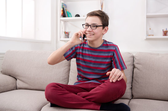Teenager has phone talk in living room at home