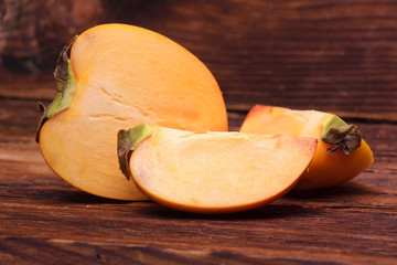 Persimmon fruit isolated on wooden board