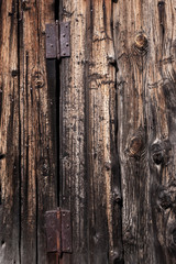 Two rusty metal loop nailed to old wooden door.